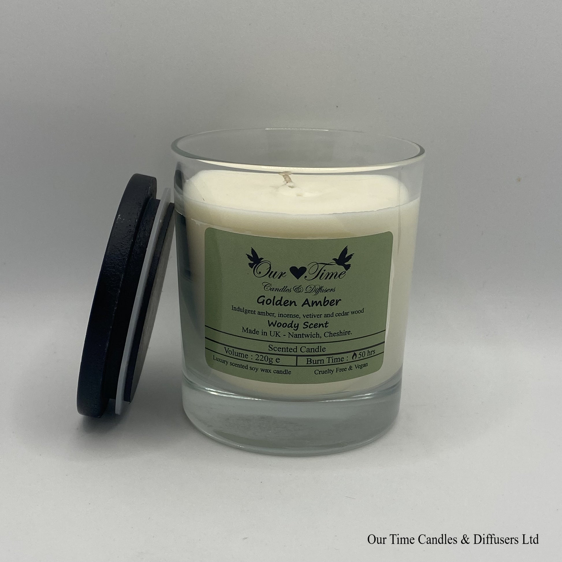 Large wax filled candle with black lid