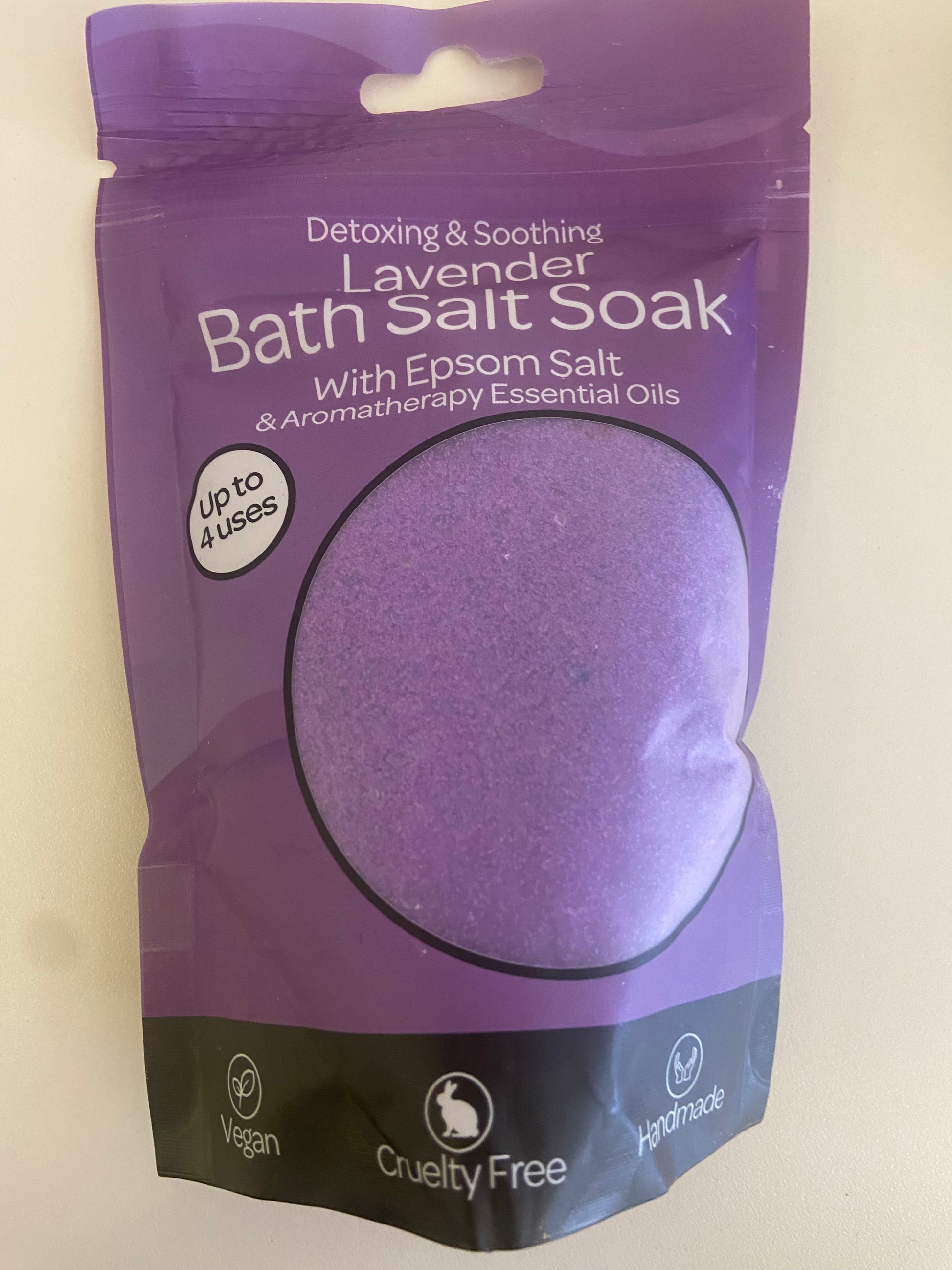 Lavender bath soak powder in a purple resealable bag