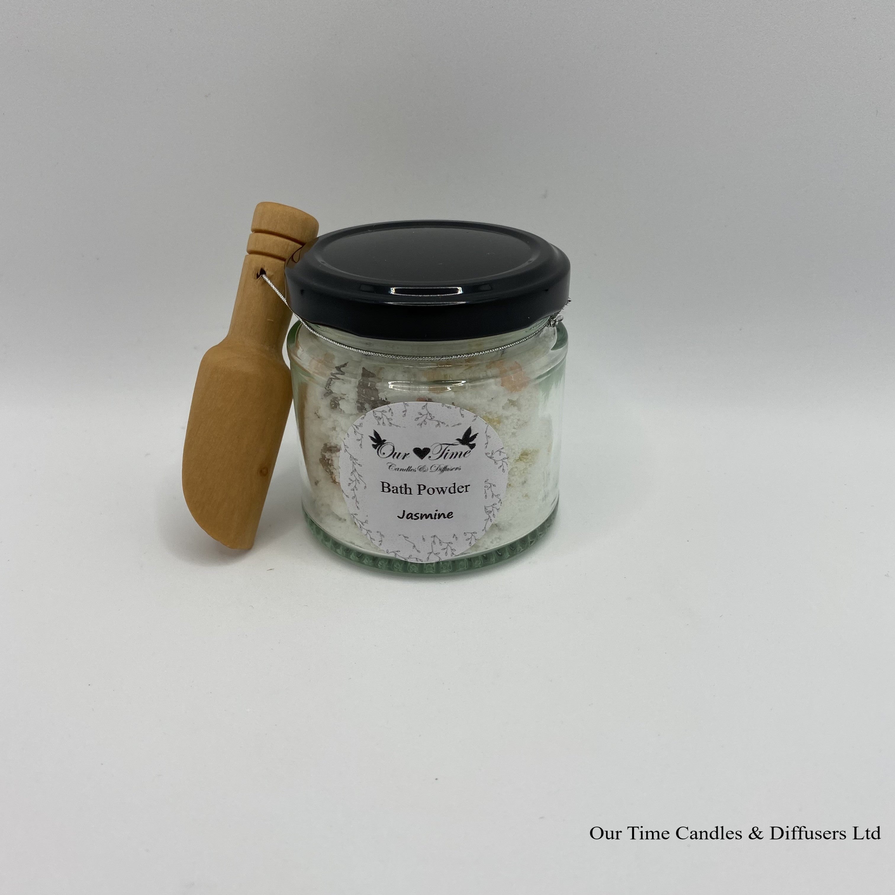 Bath Powder in a clear jar, black screw lid and wooden scoop