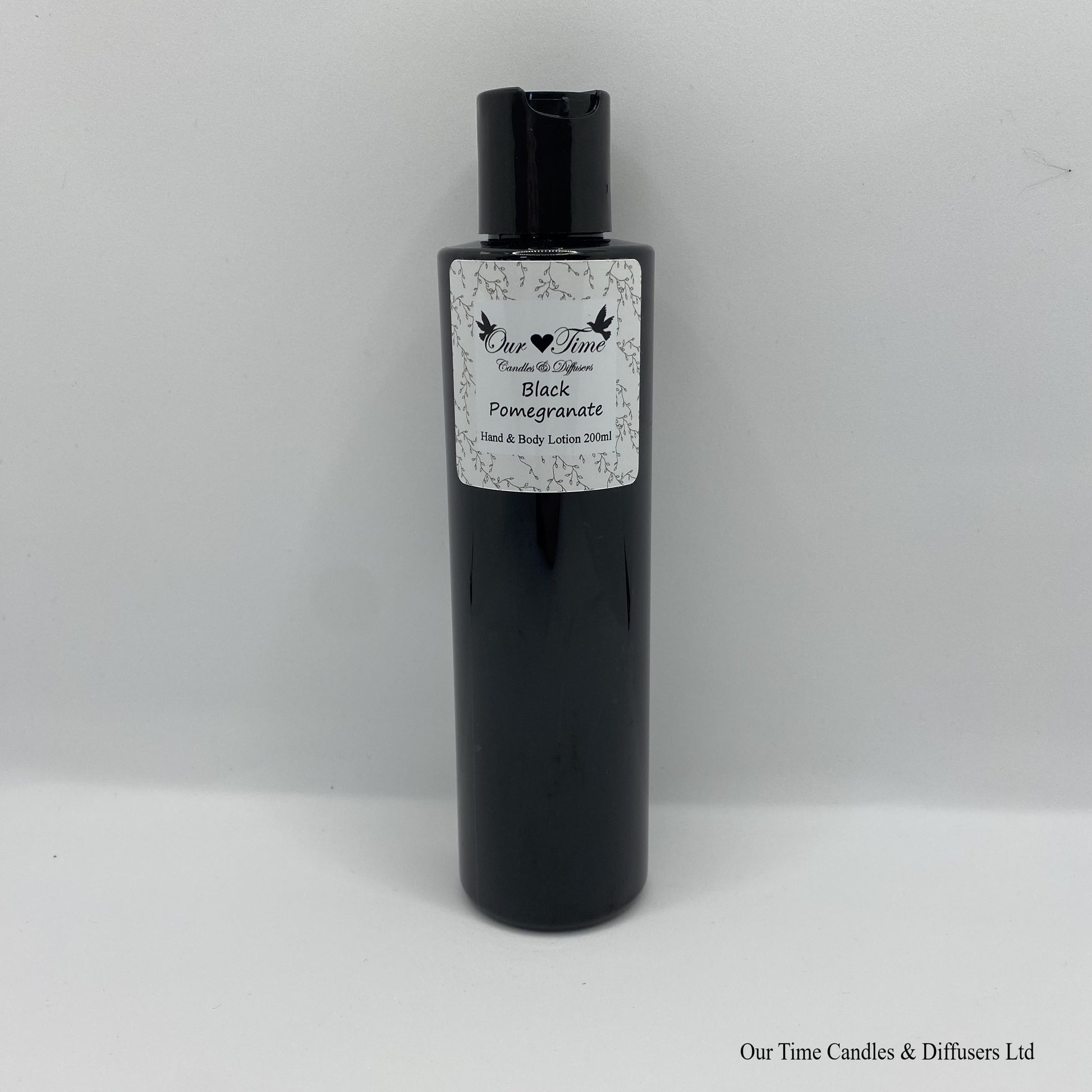 Black Bottle with black cap and white label with hand and body lotion