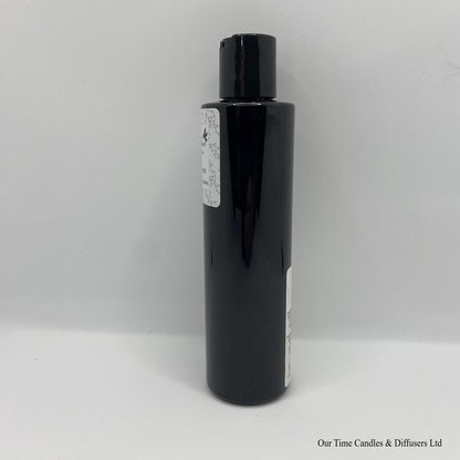 Black Bottle with black cap and white label with hand and body lotion