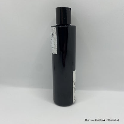 Black Bottle with black cap and white label with hand and body lotion