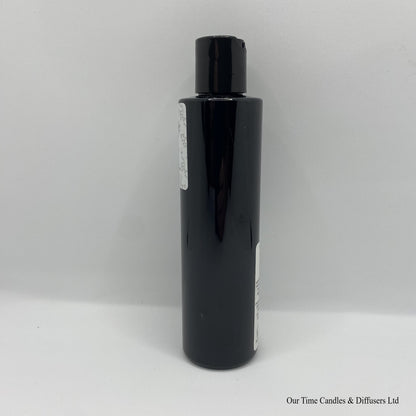 Black Bottle with black cap and white label with hand and body lotion