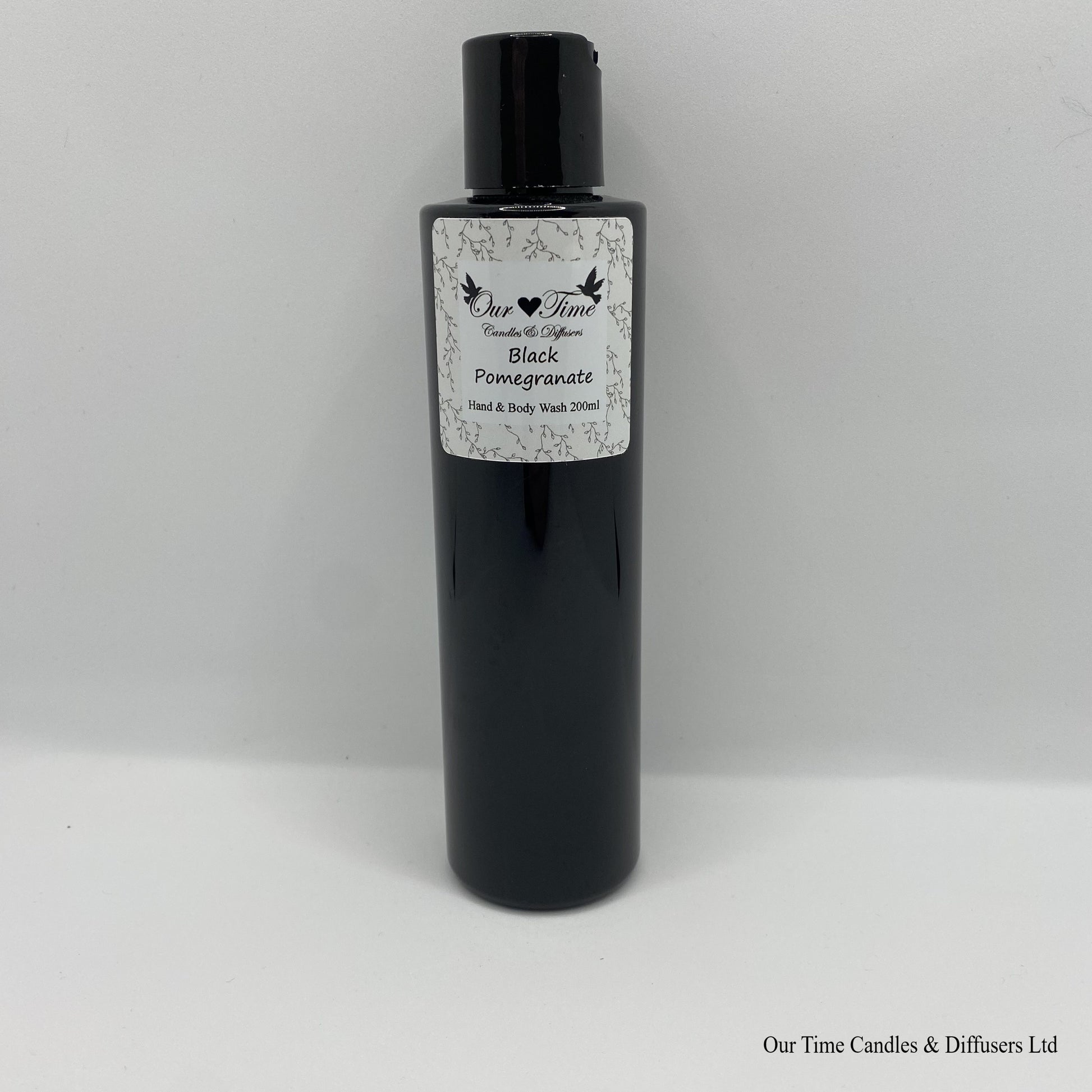 Black Bottle with black cap and white label with hand and body wash