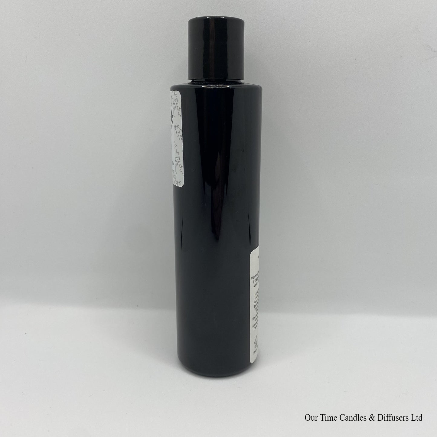 Black Bottle with black cap and white label with hand and body wash