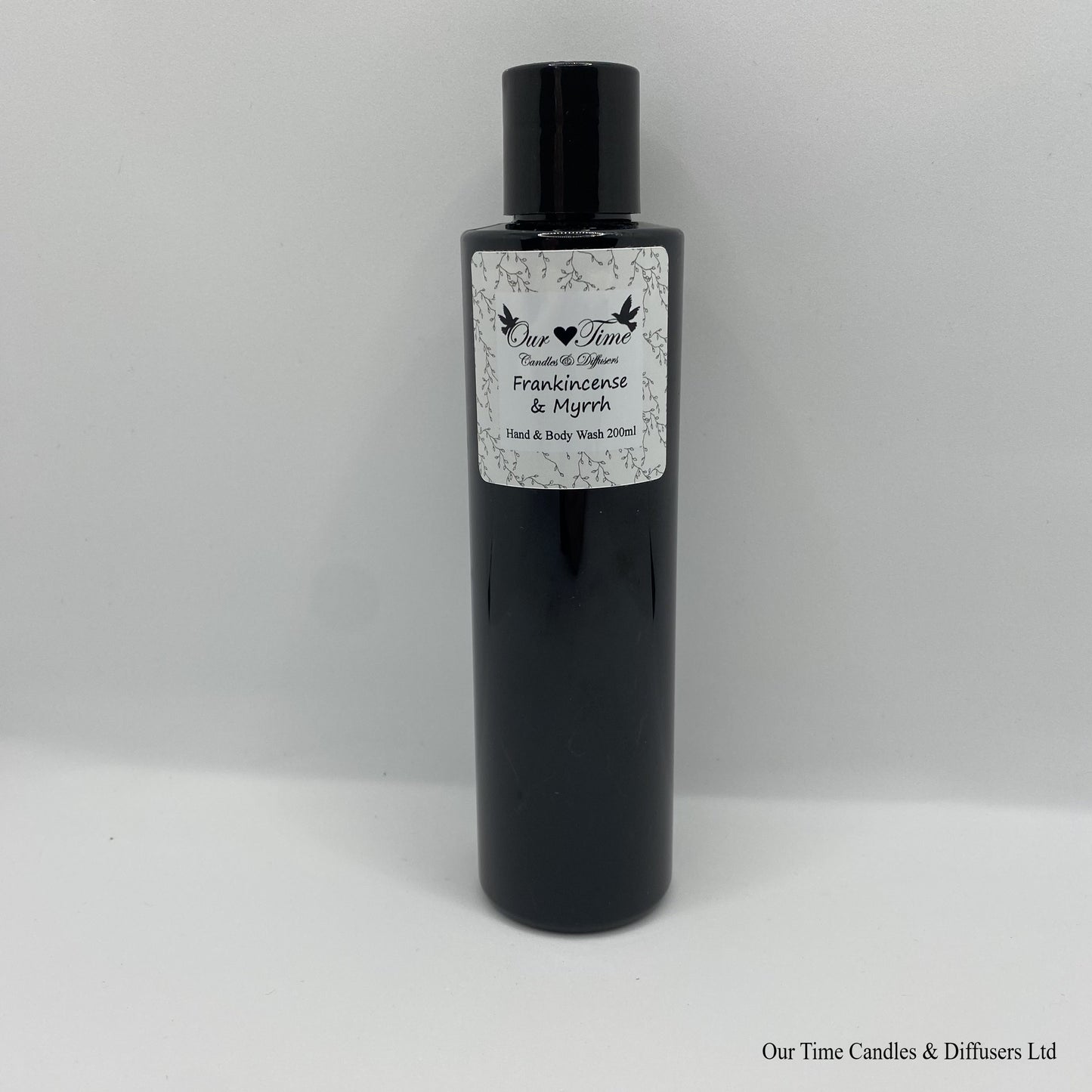 Black Bottle with black cap and white label with hand and body wash