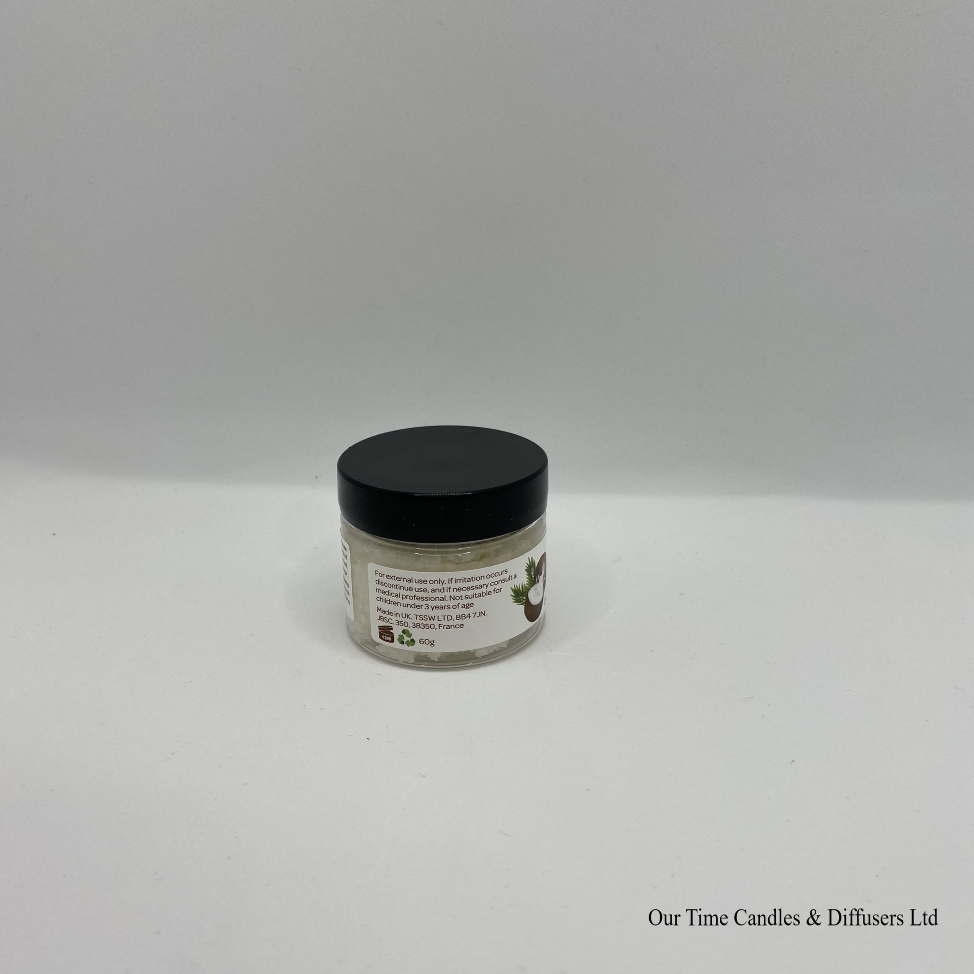 Small clear jar containing lip scrub with black lid