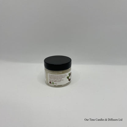 Small clear jar containing lip scrub with black lid