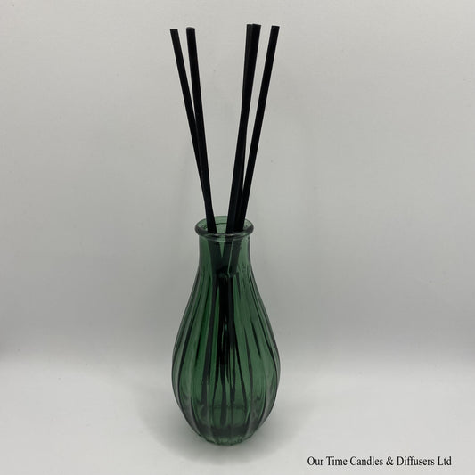 Fluted diffuser vase in green shown with reeds