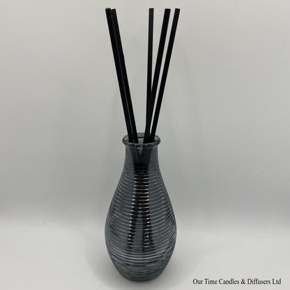 Lined diffuser vase in grey shown with reeds